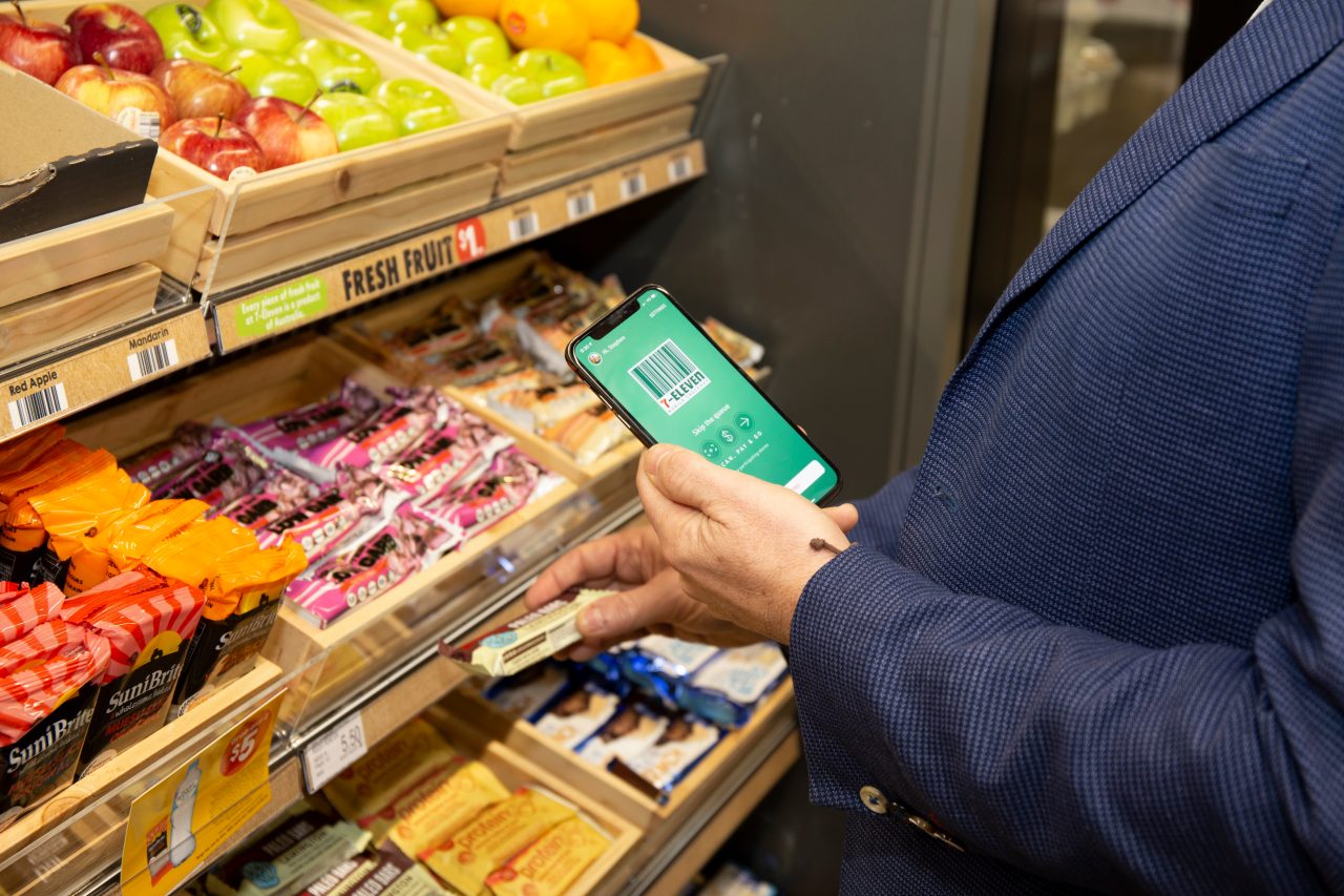 Hand holding phone with 7-Eleven payment app