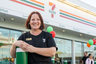 7-Eleven team member standing out the front of a store