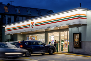 front of a 7-Eleven store at night