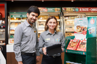 Franchisee setting up promotional material in store