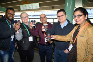7-Eleven team having a cheers with coffee cups.