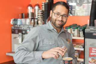 A franchisee makes a 7-Eleven coffee in his store.