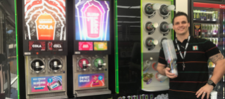 Coolum beach employee standing in front of Slurpee machine.