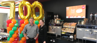 Retail staff celebrating 700th store.