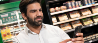 Man looking at 7-Eleven Fuel App on his phone.