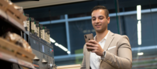 Man holding his phone in 7-Eleven store