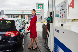 Virgin Australia Flight attendant fuelling up her car at 7-Eleven Australia store.